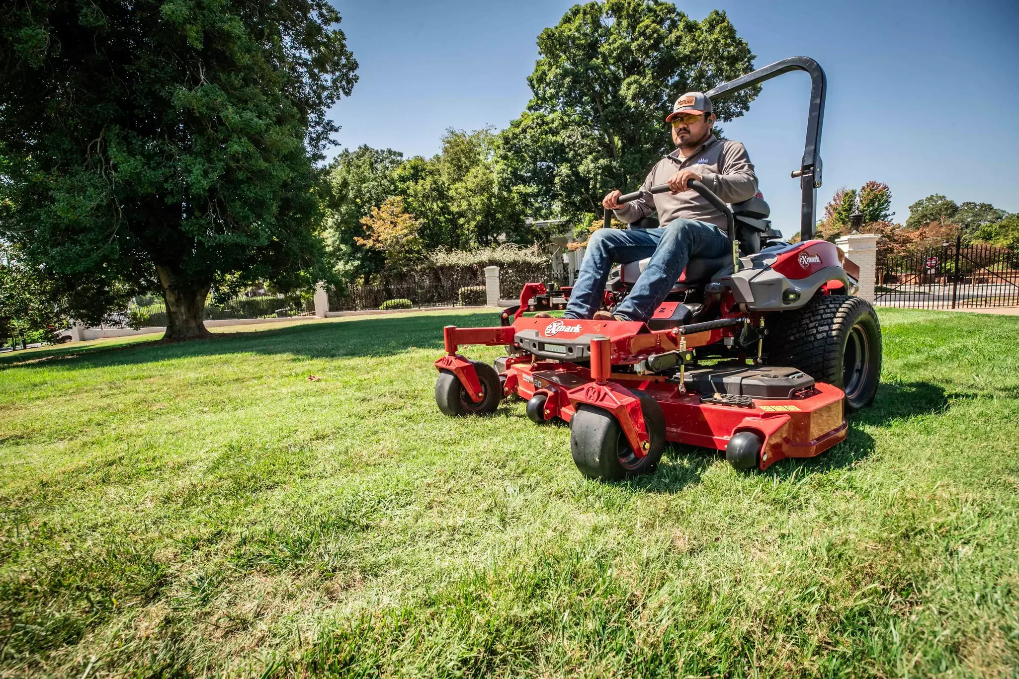 An Exmark zero-turn mower cutting a lawn